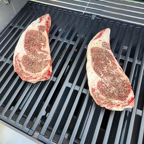 Fresh cut steaks on grill